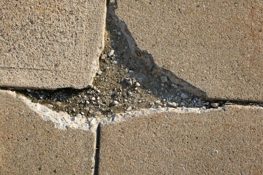 a crack in a concrete wall with a white line going through it